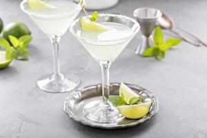 Lemonade martini cocktail garnished with lime photo