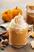 Pumpkin spice latte in a glass mug photo