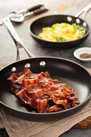 Cooked bacon on a skillet photo