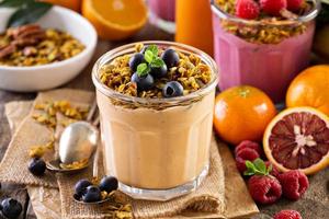 Orange mango smoothie with granola photo