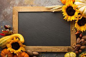 Fall chalkboard copy space with pumpkins and sunflowers photo