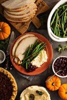 Thanksgiving plate with turkey, mashed potatoes and green beans photo