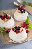 Pavlova cakes with cream and fresh berries photo