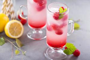Pink raspberry lemonade in tall glasses photo