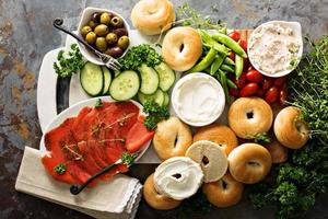 Big breakfast platter with bagels, smoked salmon and vegetables photo