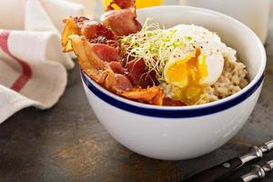 Savory oatmeal porridge with egg and bacon photo