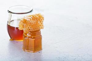 Jar of honey and honeycomb photo