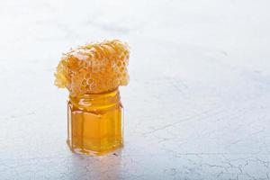 Jar of honey and honeycomb photo