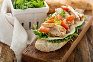 Grilled chicken sandwich with basil and tomatoes photo