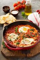 Shakshuka with chickpeas in a skillet photo