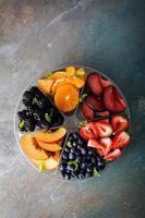 Assorted fruit and berries on a plate photo