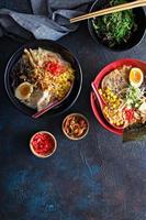 Spicy ramen bowls with noodles, pork and chicken photo