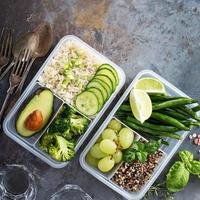 Vegan green meal prep containers with rice and vegetables photo