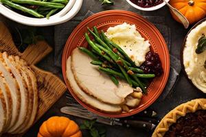 Thanksgiving plate with turkey, mashed potatoes and green beans photo