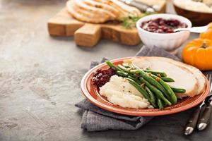 Thanksgiving plate with turkey, mashed potatoes and green beans photo