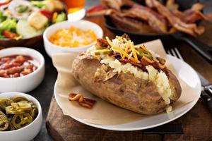 Loaded baked potato with bacon and cheese photo