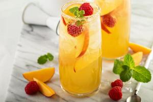 Colorful refreshing cold summer drink with peaches photo