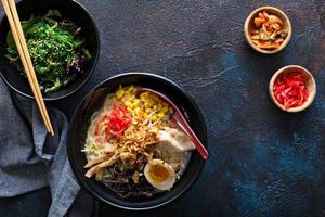 Spicy ramen bowls with noodles, pork and chicken photo