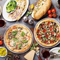 Big dinner with pizza and sandwiches photo