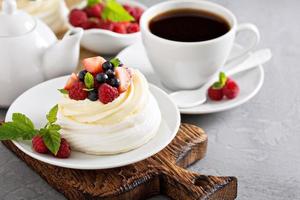 Pavlova cakes with cream and fresh berries photo