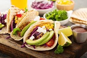 Pulled pork tacos with red cabbage and avocados photo