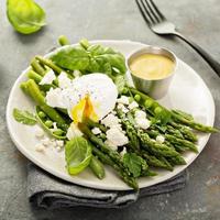 Green peas and asparagus with poached egg photo