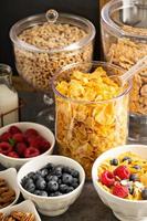 Cereal bar or buffet wih cornflakes, fruit and nuts photo