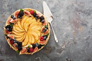 French apple tart decorated with berry photo