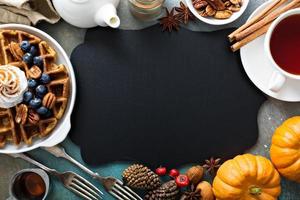 Pumpkin waffles with whipped cream for breakfast photo