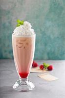 Iced milkshake with raspberry syrup and whipped cream photo