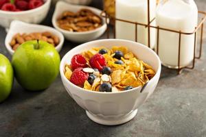 Cereal bar or buffet wih cornflakes, fruit and nuts photo