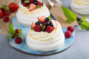 Pavlova cakes with cream and fresh berries photo