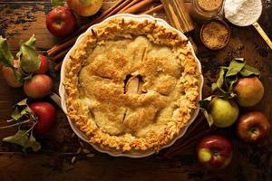 Apple pie decorated with fall leaves photo