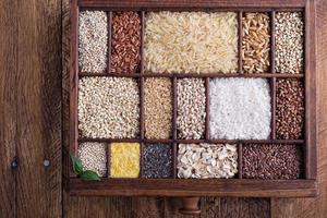 Variety of healthy grains and seeds in a wooden box photo