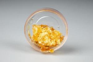 orange golden extract cannabis dab in a  bottle, wax with high thc photo