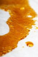 medical cannabis wax running down the paper, orange bubbles resin marijuana photo