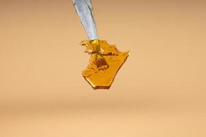 cannabis golden shatter in dab stick, wax with high thc photo