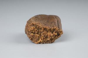 high thc cannabis, concentrate marijuana in the form of hashish amber trichomes on dark background photo
