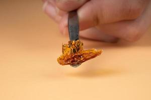 cannabis golden fresh live resin wax with high thc for stoner smoke. thc butane extract photo