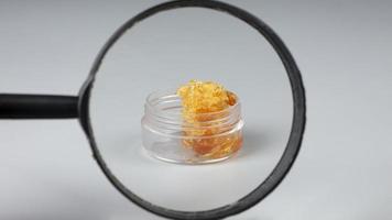 yellow gold cannabis wax in glass container, concentrate marijuana resin photo