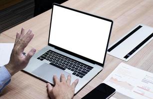 Businessman raise your hand with white screen background mock up on display laptop with clipping path photo