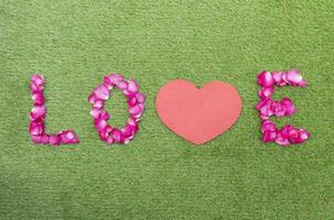 Top view rose petals in a row of love with mock up red heart. Valentine day concept photo