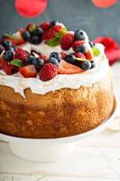 Angel food cake with whipped cream and berries photo