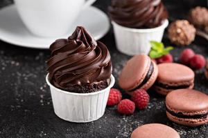 Chocolate cupcakes with thick and glossy frosting photo