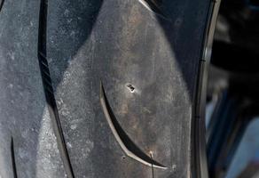 Motorcycle tire leaks due to nail photo
