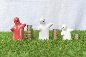 Mock up family statue and coins stack on grass floor with white background photo