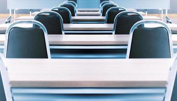 Close up the chair in in seminar room with a speaker table in the middle of the stage photo