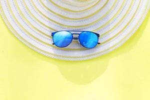 Travel vacation background. Sun glasses yellow background. Concept summer holidays. photo