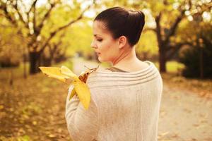 girl walking in the park in autumn photo