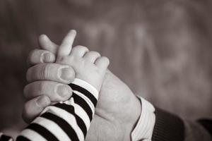 Little hand of the child in the fathers hand photo